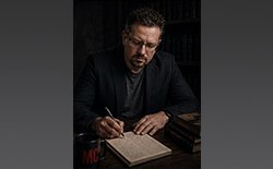 Martin Caldwell writing on pad
